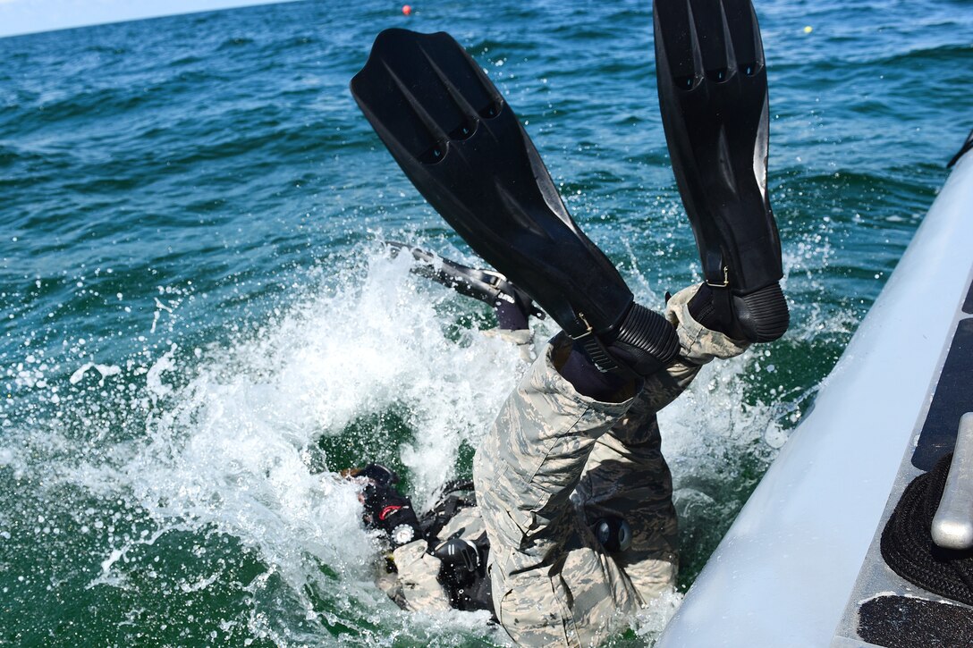 An Air Force diving student makes his initial dive during a recovery exercise.