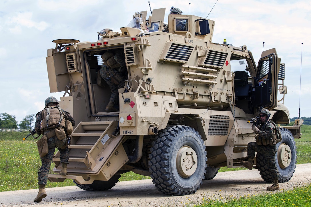 Troops board a vehicle.