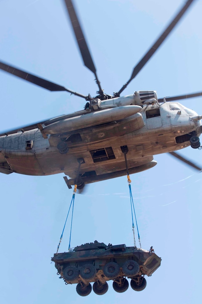 A U.S. Marine CH-53E helicopter transports a LAV-25 through the air during a Helicopter Support Team exercise on Marine Corps Base Camp Pendleton, Calif., Aug. 22, 2017. The exercise will provide lessons and information to build on and familiarize units with fundamental rigging procedures to facilitate an HST. (U.S. Marine Corps photo by Lance Cpl. Gabino Perez)