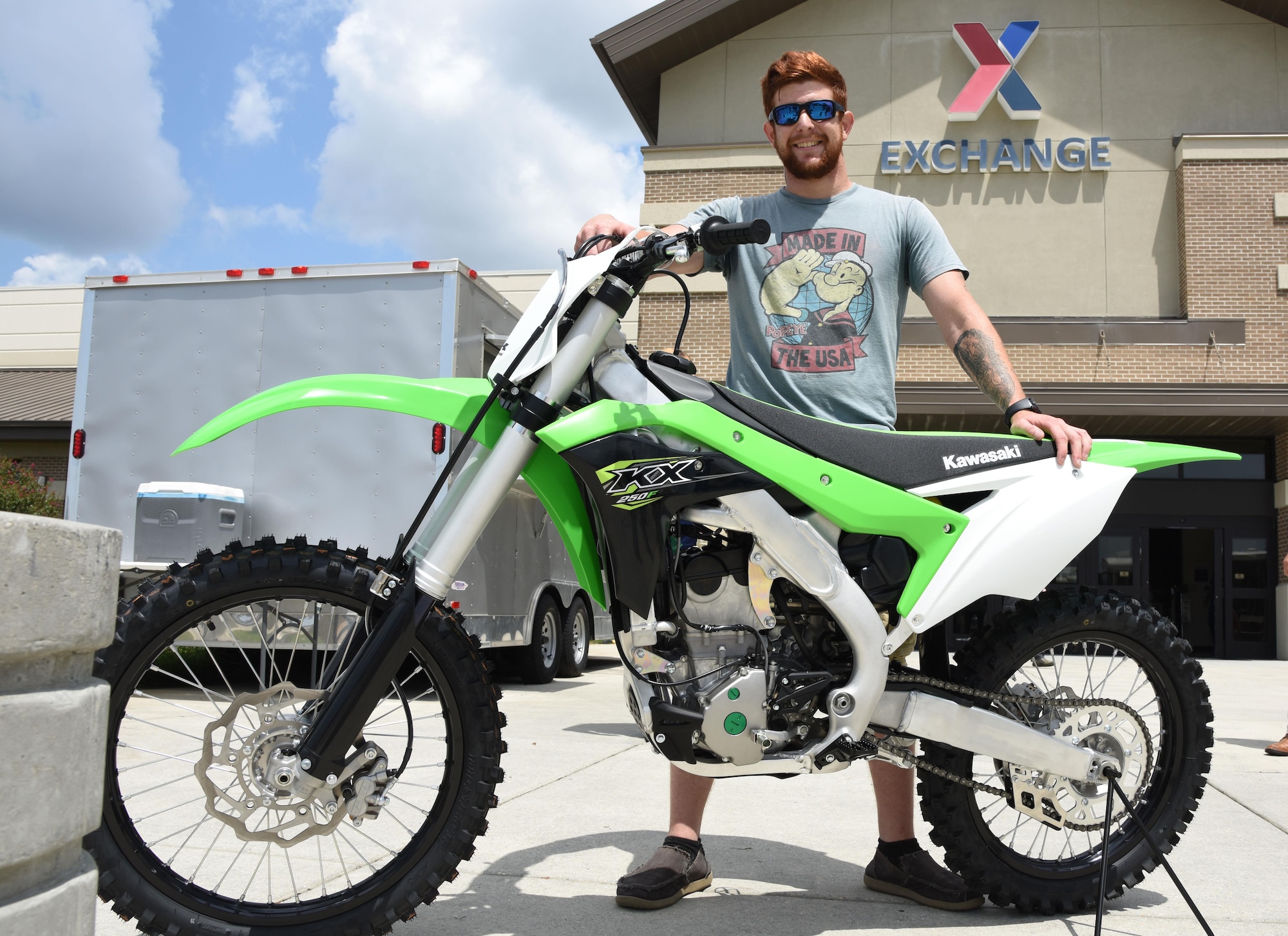 U.S. Army Spc. Anthony Clark, Alpha Company 1-155th infantryman, Mississippi National Guard, Biloxi, Miss., poses for a photo with the Kawasaki KXTM250F motorcycle that he was presented with at the Base Exchange, Aug. 19, 2017, on Keesler Air Force Base, Miss. Clark, a Biloxi native, was randomly selected from more than 16,000 entries to win the Army & Air Force Exchange Service’s Monster Kawasaki Sweepstakes, which ran from April 15 to May 31. (U.S. Air Force photo by Kemberly Groue)