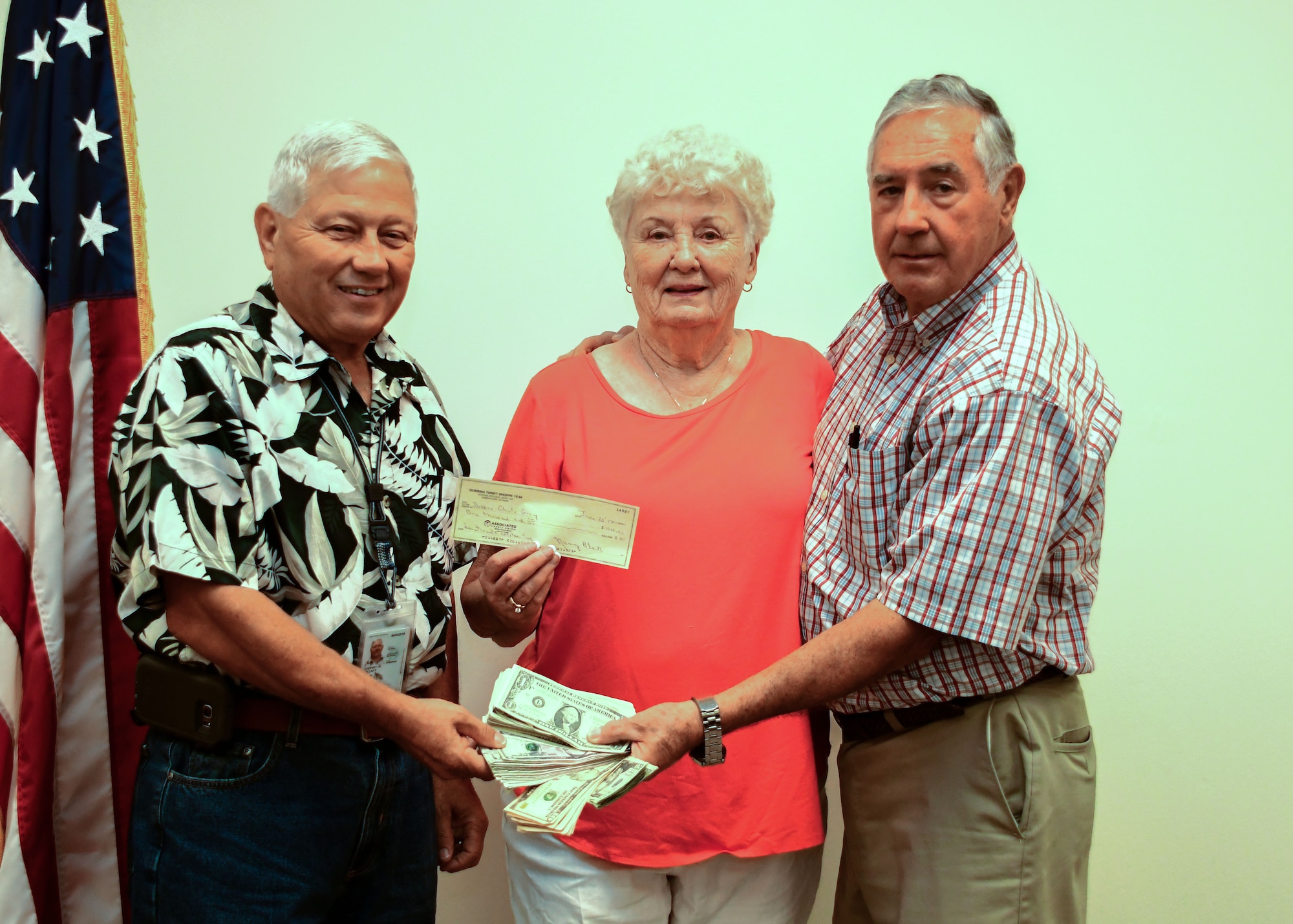 From left, Dallas Godfrey, Square and Compass Club Corn and Sausage Roast chairman, Nancy Black, Dobbins thrift shop manager, and Ron Durant, Square and Compass Club secretary, present the earnings from this year's Corn and Sausage Roast Fundraiser at Dobbins Air Reserve Base, Ga. Aug. 17, 2017. The event raised $2,004, which will go toward helping military families with unexpected expenses while a service member is deployed. (U.S. Air Force photo/Staff Sgt. Andrew Park)