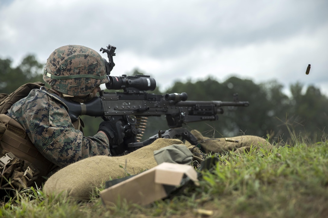 A Marine fires a machine gun.