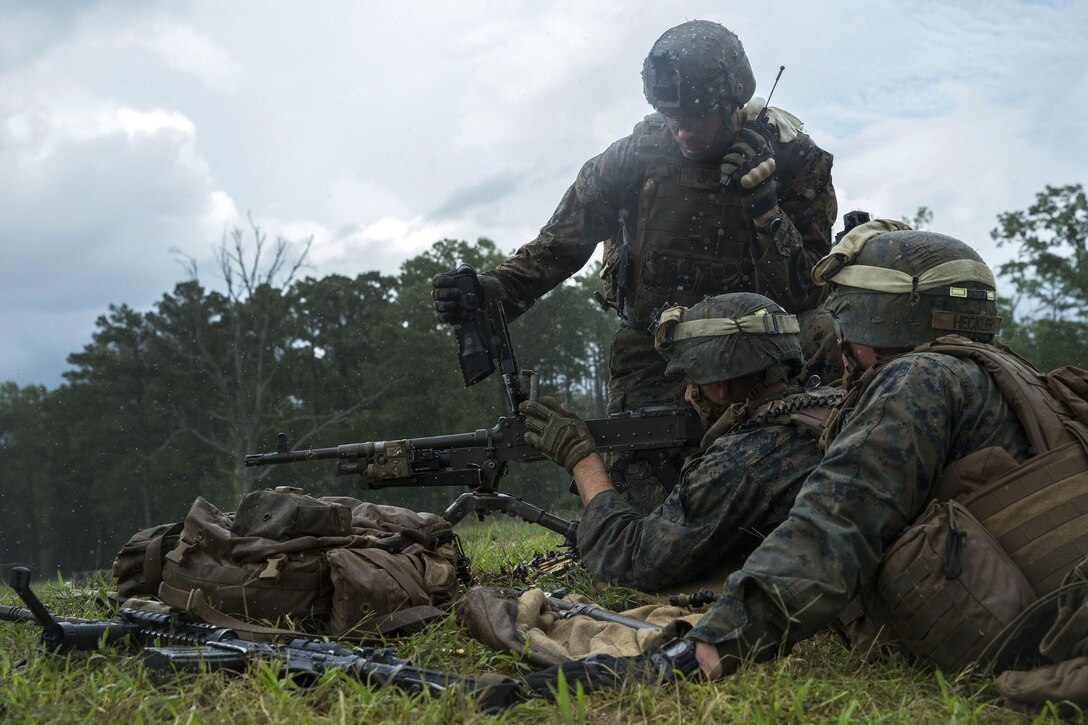 A Marine clears a machine gun.