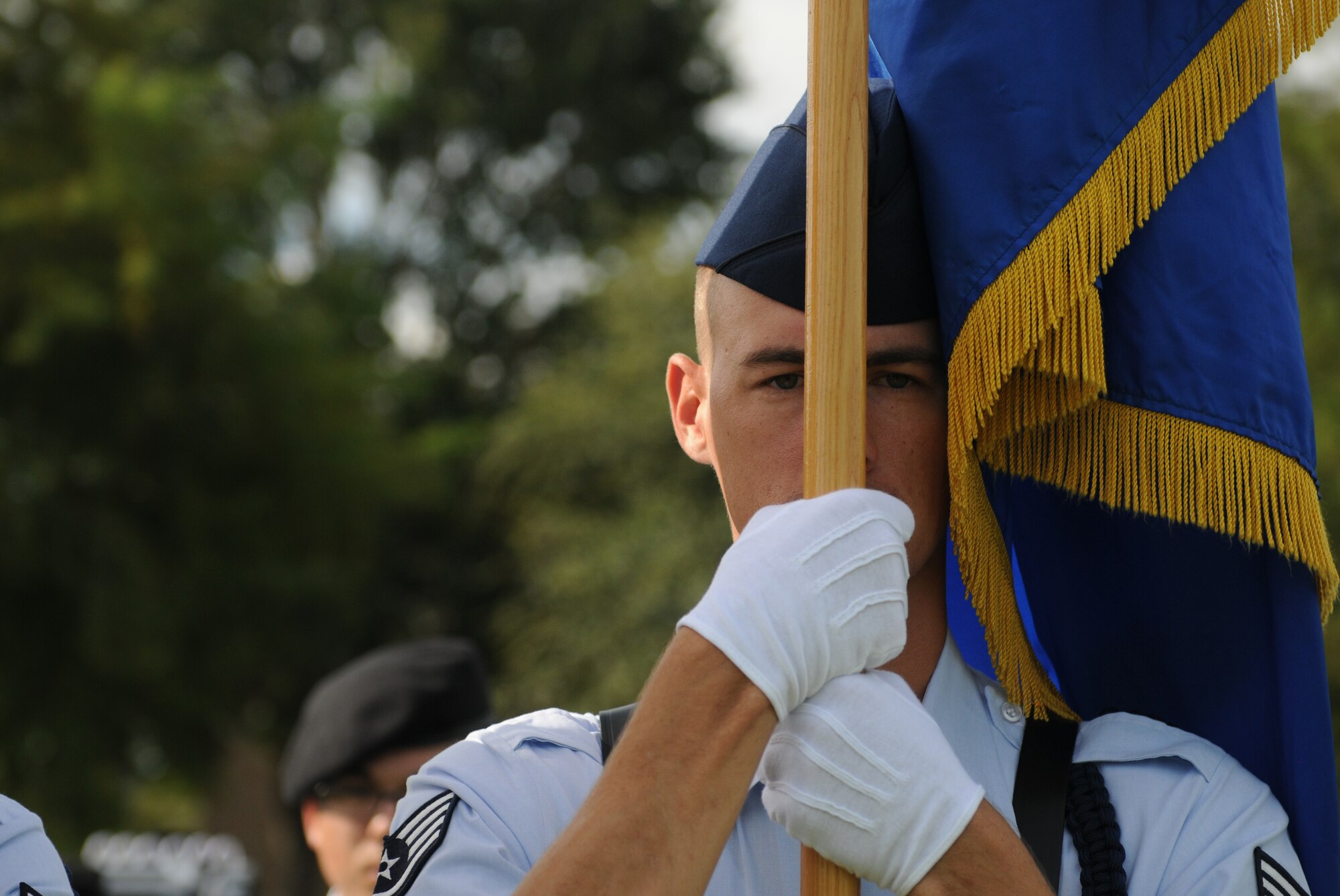 Staff Sgt. David Edmondson, 336th Training Squadron military training leader, holds the Air Force flag during the 2nd Air Force change of command ceremony at the Levitow Training Support Facility Aug. 23, 2017, on Keesler Air Force Base, Miss. Maj. Gen. Timothy Leahy took command of 2nd AF during the ceremony from Maj. Gen. Bob LaBrutta. (U.S. Air Force photo by Senior Airman Holly Mansfield)