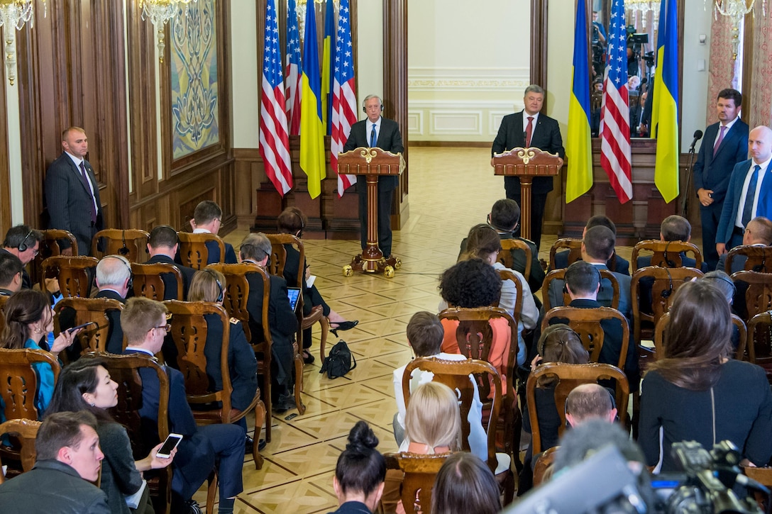 Defense Secretary Jim Mattis and the Ukrainian president speak from behind podiums to a room of reporters.