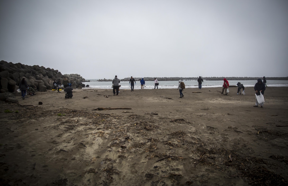 Service members pick up trash at Miss Veedol Beach, Misawa, Japan, August 19, 2017, during Exercise Northern Viper 2017. Marines, Sailors, Airmen banded together with Misawa City employees to participate in the beach cleanup. NV17 tests the interoperability and bilateral capability of the Japan Ground Self-Defense Force and U.S. Marine Corps forces to enhance regional cooperation between participating nations to collectively deter security threats. (U.S. Marine Corps photo by Lance Cpl. Andy Martinez)