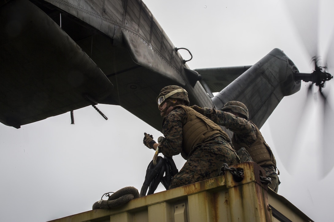 Pfc. Tyler J. Nye (left) and Cpl. Tyler D. Reed (right), both landing support specialist, prepare to attach a container to a CH-53E Super Stallion during external lifts training at Draughon Range near Misawa Air Base, Japan, August 21, 2017, in support of exercise Northern Viper 17. This combined-joint exercise is held to enhance regional cooperation between participating nations to collectively deter security threats. Nye, a Lincoln, Nebraska native, and Reed, a Waukesha, Wisconsin native, are assigned to Combat Logistics Battalion 4, Combat Logistics Regiment 3, 3rd Marine Logistic Group. (U.S. Marine Corps photo by Lance Cpl. Andy Martinez)