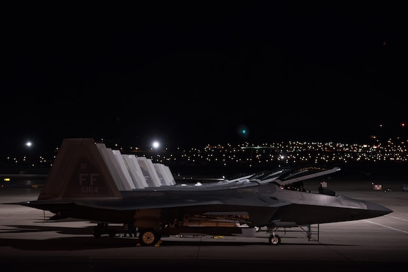 U.S. Air Force F-22 Raptors are at the ready for the night mission at Red Flag 17-4 at Nellis Air Force Base, Nev., Aug. 21, 2017.  During the mission Capt. Flash, 94th Fighter Squadron pilot, will complete his mission commander upgrade certification. (U.S. Air Force photo by Staff Sgt. Carlin Leslie)