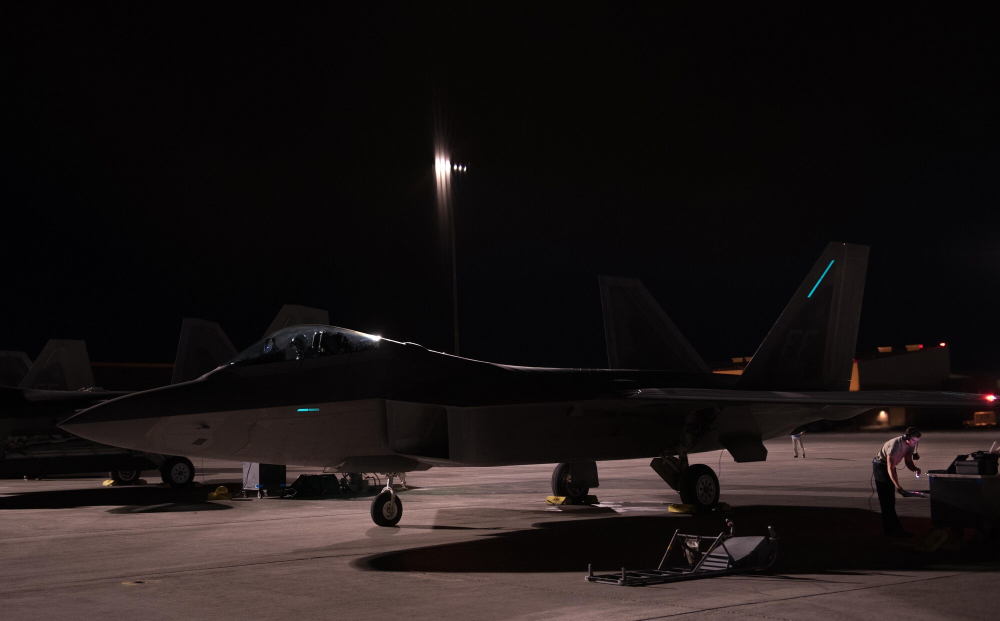 U.S. Air Force Capt. Flash, 94th Fighter Squadron pilot, starts engines on a F-22 Raptor, during his mission commander upgrade certification at Red Flag 17-4 at Nellis Air Force Base, Nev., Aug. 21, 2017. Receiving this certification will now allow Flash to command a mission for joint service and coalition partners in the area of responsibility if called upon to do so.  (U.S. Air Force photo by Staff Sgt. Carlin Leslie)