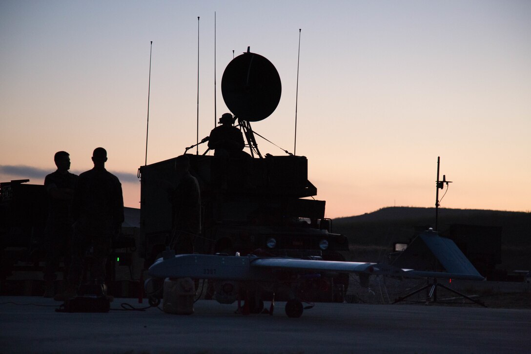 U.S. Marines with Marine Unmanned Aerial Vehicle Squadron 4, Marine Aircraft Group 41, Marine Forces Reserve configure satellites before the launch of the RQ-7 Shadow Tactical Unmanned Aircraft System on Camp Pendleton, Calif., August 19th, 2017. The RQ-7 is helping VMU-4 make history as it is utilized to conduct yearly surveys of deer and buffalo populations on the base, a job formerly tasked to manned helicopters. In addition to offering a low-cost solution to conducting wildlife surveys, the exercise also provides valuable training to Marines who are learning to use the UAVs for aerial reconnaissance in areas of conflict.