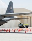 Firefighters with the Qatar Emiri Air Force Fire Department hose down a C-130 Hercules from Dobbins Air Force Reserve, Georgia, during a joint C-130 Hercules aircraft exercise at Al Udeid Air Base, Qatar, Aug. 1, 2017. The firefighters are taking part in a simulated aircraft explosion exercise with the 379th Expeditionary Civil Engineer Squadron’s Fire and Emergency Services Flight, where they worked together to extinguish the fire and safe lives. (U.S. Air Force photo by Tech. Sgt. Amy M. Lovgren)