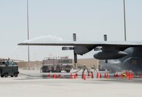 Firefighters with the 379th Expeditionary Civil Engineer Squadron’s Fire and Emergency Services Flight hose down a C-130 Hercules from Dobbins Air Force Reserve, Georgia, during a joint C-130 Hercules aircraft exercise at Al Udeid Air Base, Qatar, Aug. 1, 2017.