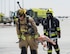 Firefighters with the 379th Expeditionary Civil Engineer Squadron’s Fire and Emergency Services Flight, left, and the Qatar Emiri Air Force Fire Department carry a simulated patient during a joint C-130 Hercules aircraft exercise at Al Udeid Air Base, Qatar, Aug. 1, 2017. The firefighters are taking part in a simulated aircraft explosion exercise, working together to extinguish the fire and save lives. (U.S. Air Force photo by Tech. Sgt. Amy M. Lovgren)