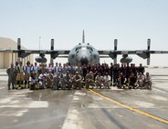 Firefighters with the 379th Expeditionary Civil Engineer Squadron’s Fire and Emergency Services Flight and the Qatar Emiri Air Force Fire Department pose for a group photo after a joint exercise at Al Udeid Air Base, Qatar, Aug. 1, 2017.