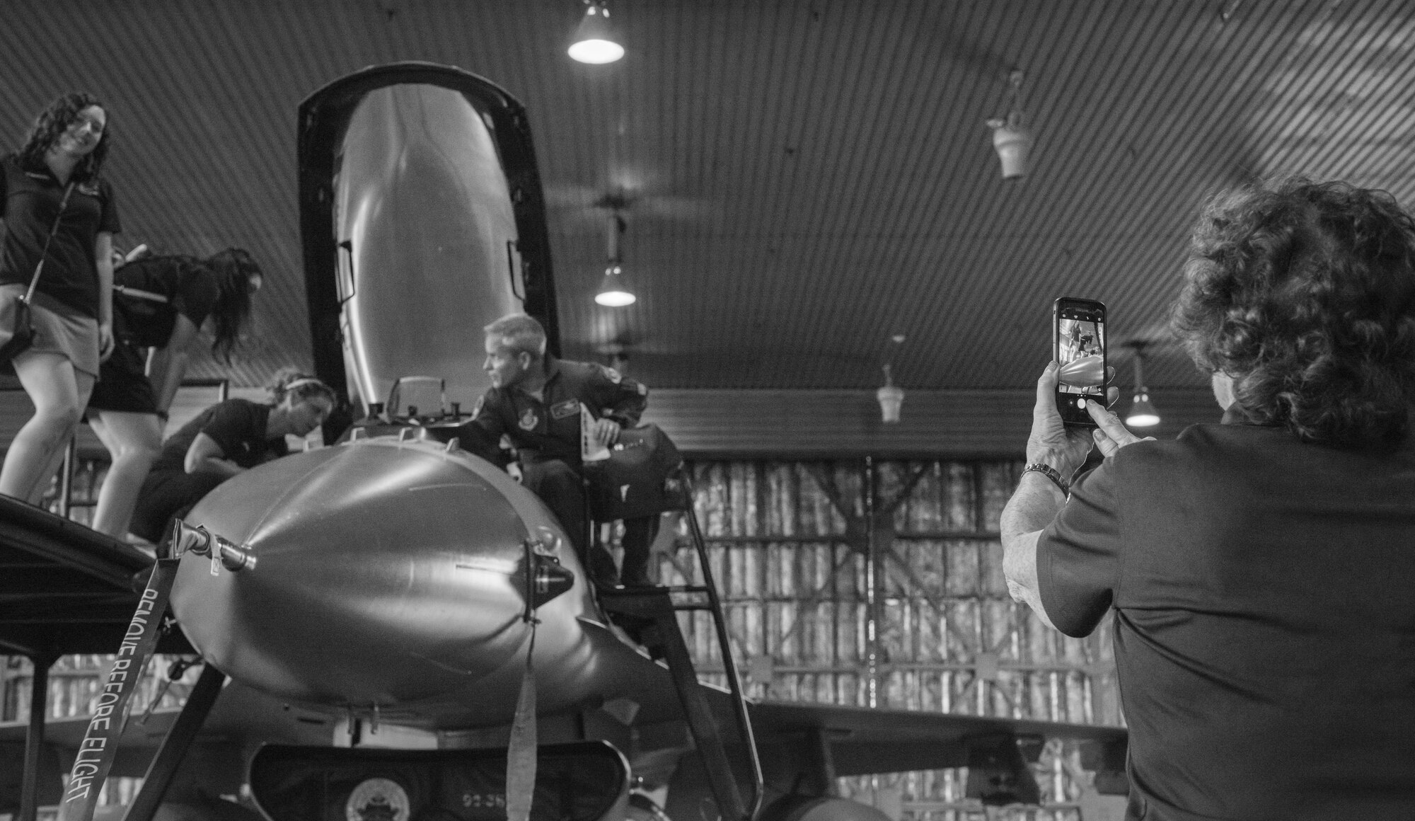 The grandmother of a high school student takes her granddaughter’s photo as Col. Paul Kirmis, the 35th Fighter Wing vice commander, explains what it’s like flying in an F-16 Fighting Falcon in the Indo-Asia-Pacific region during the Wenatchee Valley delegation visit at Misawa Air Base, Japan, Aug. 24, 2017.