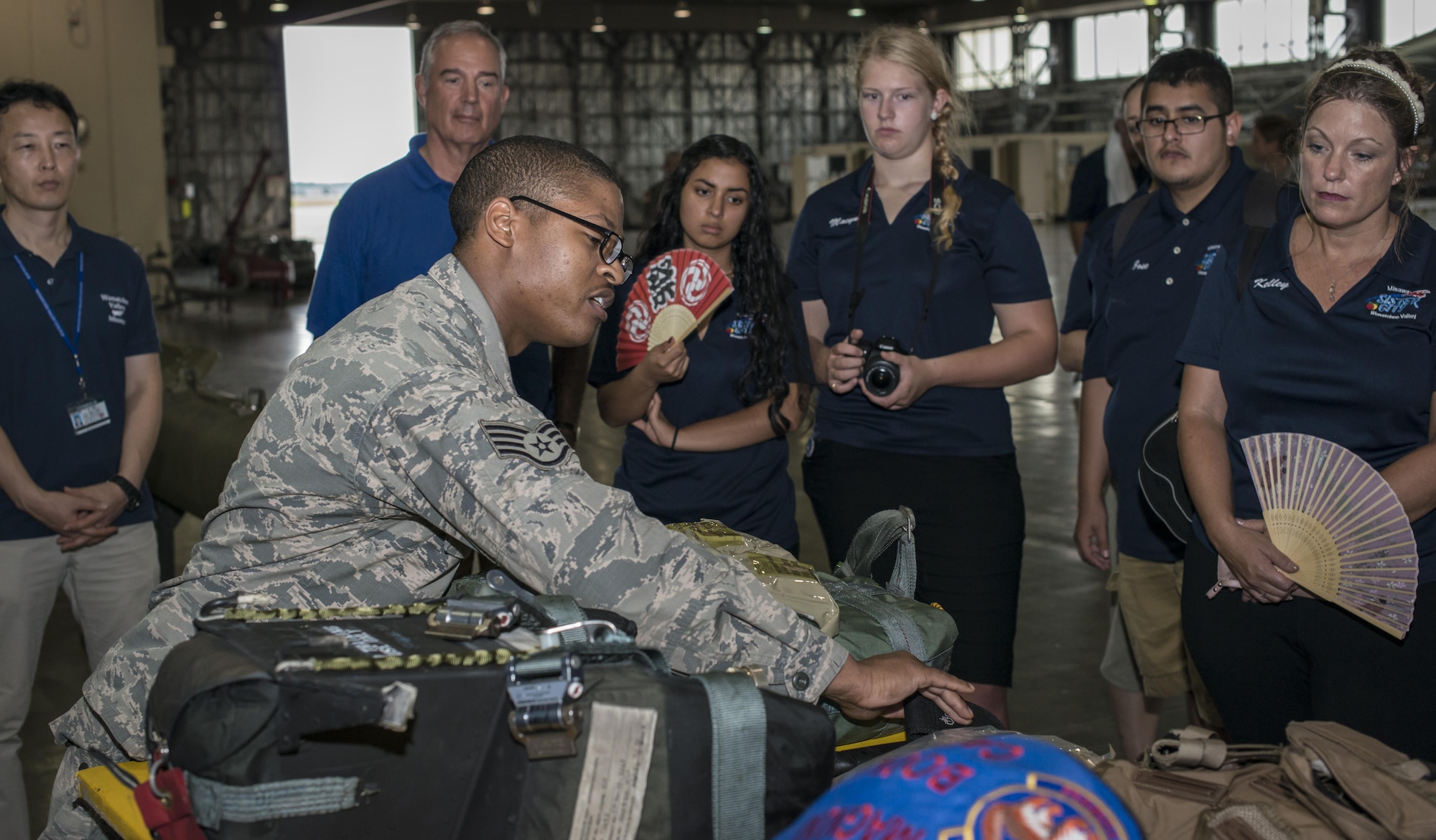 U.S. Air Force Staff Sgt. Travis Tillman, a 35th Operations Support Squadron aircrew flight equipment technician, explains how his section sustains a pilot’s life during flying operations as part of the Wenatchee Valley Delegate visit at Misawa Air Base, Japan, Aug. 24, 2017.