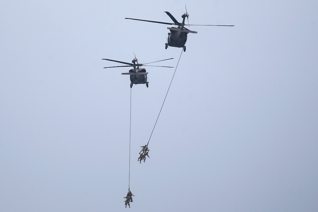 Army UH-60 Black Hawk helicopters demonstrate a Special Patrol Insertion & Exfiltration System.