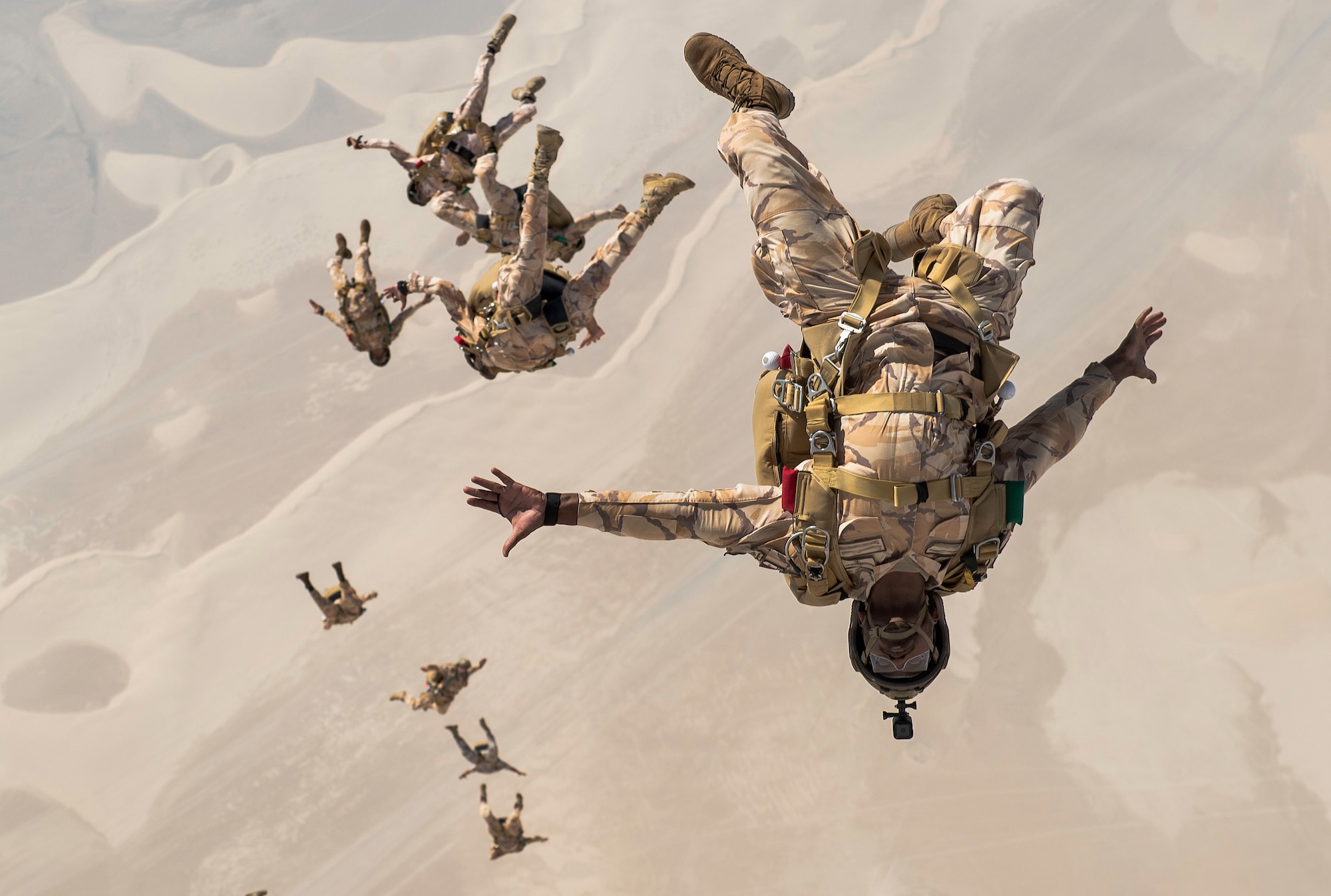 Qatari special operations personnel conduct a military free-fall Friendship Jump over Qatar on Aug. 21, 2017. In support of continued partnerships between the U.S. and Qatar, special forces from the two nations participated in a static-line and military free-fall parachute training exercise. This marked the first event of its kind conducted between the U.S. and Qatar, allowing the enhanced interoperability between special forces from both nations. (U.S. Air Force photo by Staff Sgt. Trevor T. McBride)