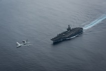 (Aug. 21, 2017) A U.S. Air Force E-3 Sentry airborne warning and control system assigned to Air Combat Command at Tinker Air Force Base flies over the aircraft carrier USS Theodore Roosevelt (CVN 71). Theodore Roosevelt is underway conducting a composite training unit exercise (COMPTUEX) with its carrier strike group in preparation for an upcoming deployment. COMPTUEX tests a carrier strike group's mission-readiness and ability to perform as an integrated unit through simulated real-world scenarios. (U.S. Navy photo by Mass Communication Specialist 3rd Class Anthony J. Rivera)
