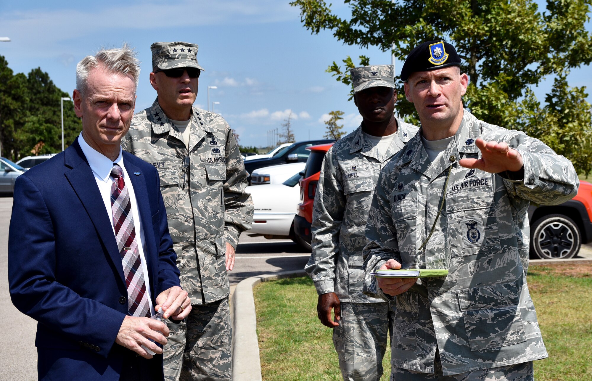 Lt. Col. Keith Quick, 72nd Security Forces Squadron commander, right, Lt. Gen. Lee K. Levy II, Air Force Sustainment Center commander, second from left, and Col. Kenyon Bell, 72nd Air Base Wing commander, discuss perimeter security issues with U.S. Rep. Steve Russell, R-Okla., during a brief visit to Tinker Air Force Base Aug. 10.