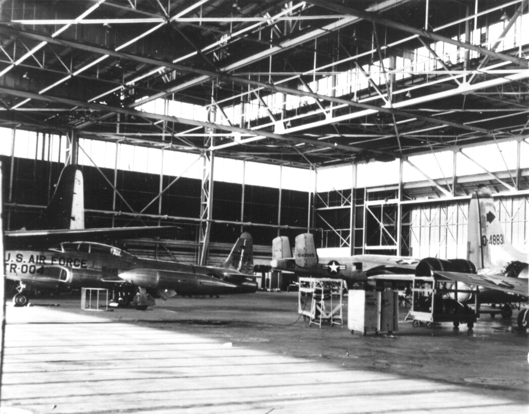 A T-33A Shooting Star wearing natural-metal and large aircraft identification markings sits inside a hangar at Tinker Air Force Base, Oklahoma in this undated photo from the Tinker archives.