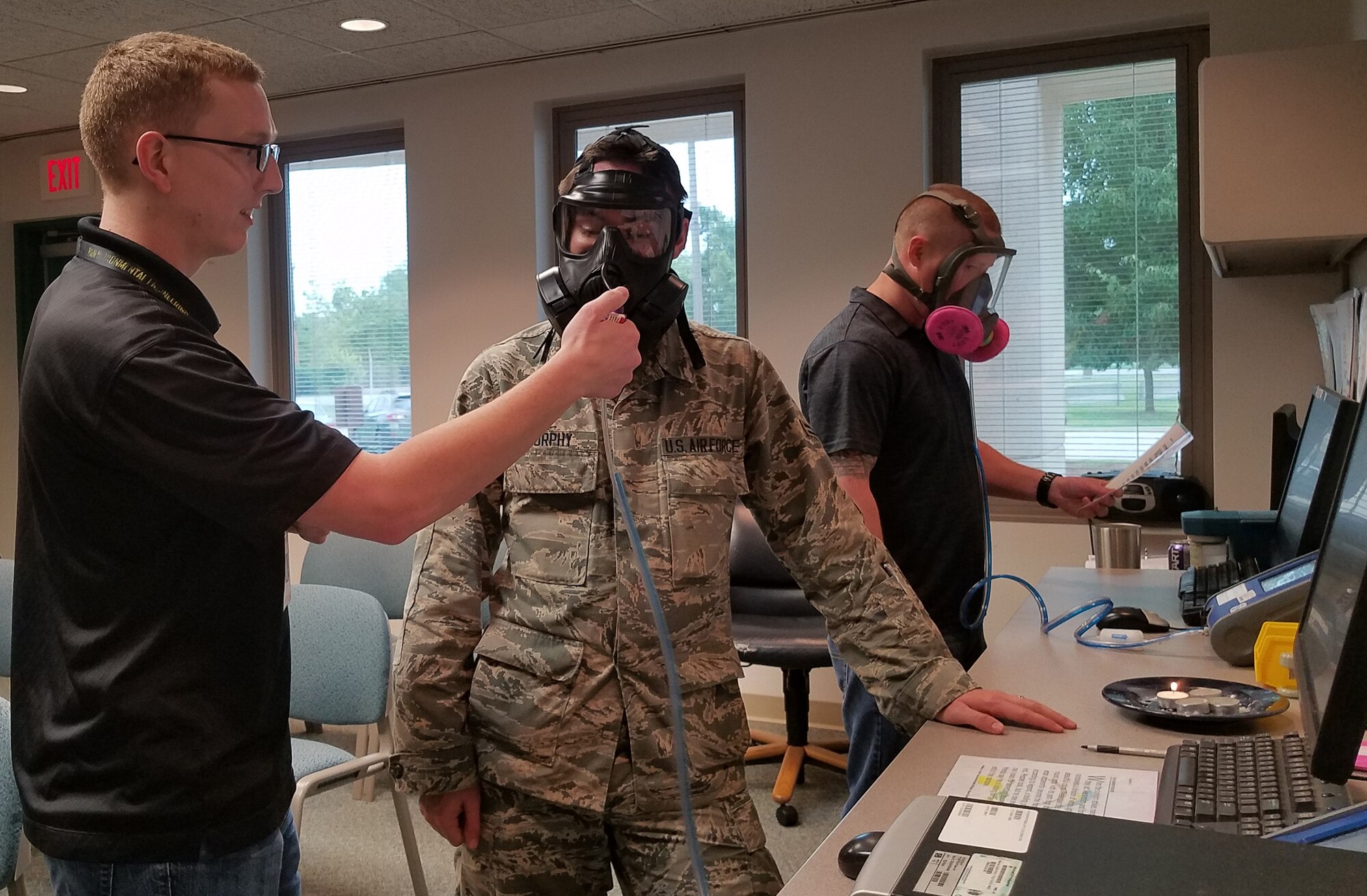 Tyler Miner of the 72nd Aerospace Medicine Squadron’s Bioenvironmental Engineering Flight conducts a gas mask fit test to a military member while a civilian member is getting his industrial respirator fit tested so they will be protected from potential airborne hazards produced during their specific maintenance processes