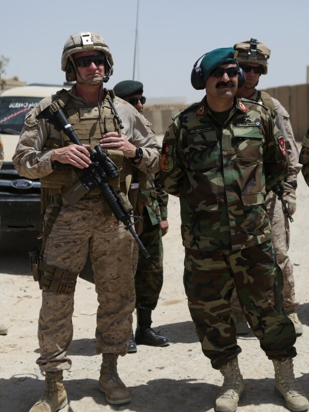 U.S. Marine Brig. Gen. Roger Turner, the commanding general of Task Force Southwest, and Brig. Gen. Wali Mohammed Ahmadzai, the commanding general of 215th Corps, await CH-47 Chinooks during Operation Maiwand Five near Nawa, Afghanistan, Aug., 21, 2017. Several advisors with the Task Force are assisting their Afghan counterparts throughout the operation, which is designed to clear insurgents from the Nawa district in Helmand province and help promote security and stability in the region. (U.S. Marine Corps photo by Cpl. Tyler Harrison)