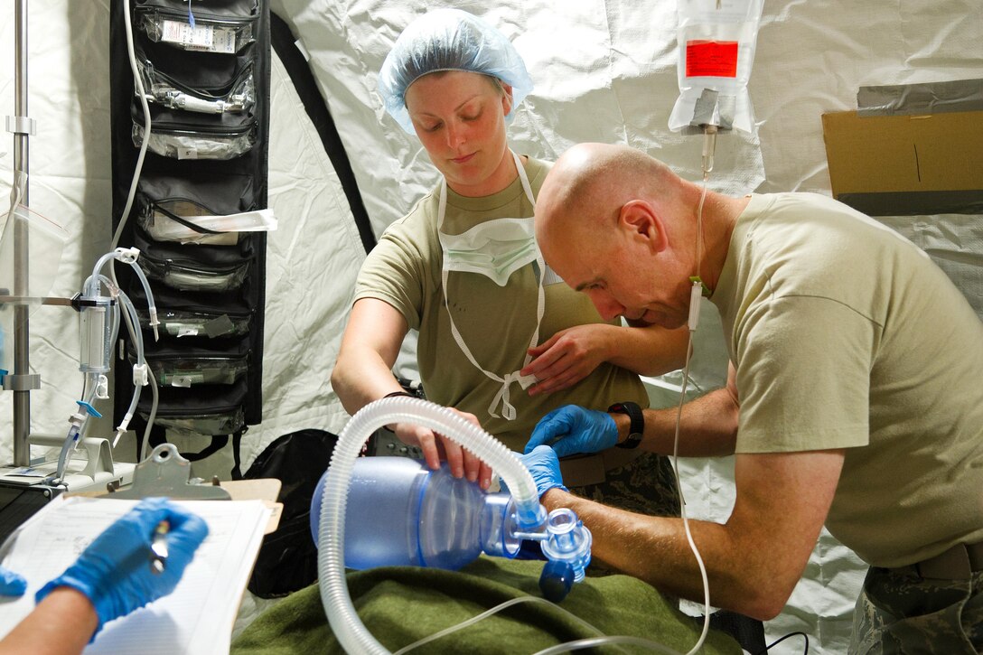Airmen intubate a simulated patient.