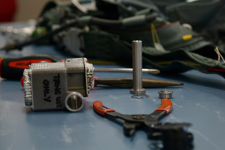 Airmen of the 509th Operations Support Squadron set out tools used to inspect the parachutes at Whiteman Air Force Base, Mo., Aug. 21, 2017. The technicians use pliers and screwdrivers to dissemble, inspect and reassemble parts of the parachutes to ensure they function correctly.