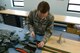 U.S. Air Force Senior Airman Thomas Cadwell, an air-crew flight equipment technician assigned to the 509th Operations Support Squadron, inspects a four-line re-lease at Whiteman Air Force Base, Mo., Aug. 21, 2017. The four-line release is used after the pilot has ejected and needs to steer the parachute to keep it from landing in an unsafe area.