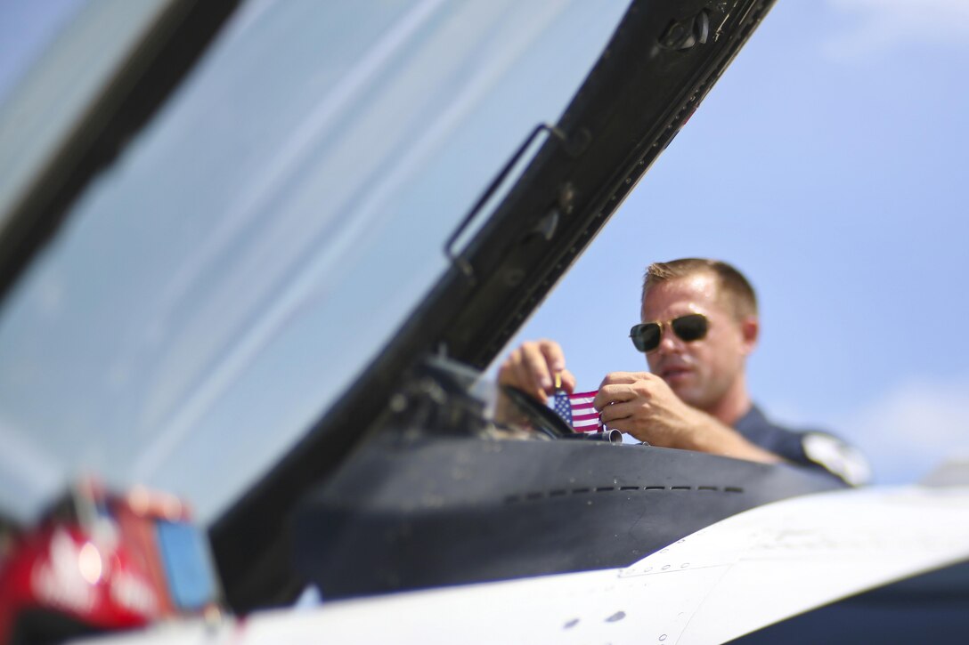 Staff Sgt. Kyle Smith adjusts the American Flag