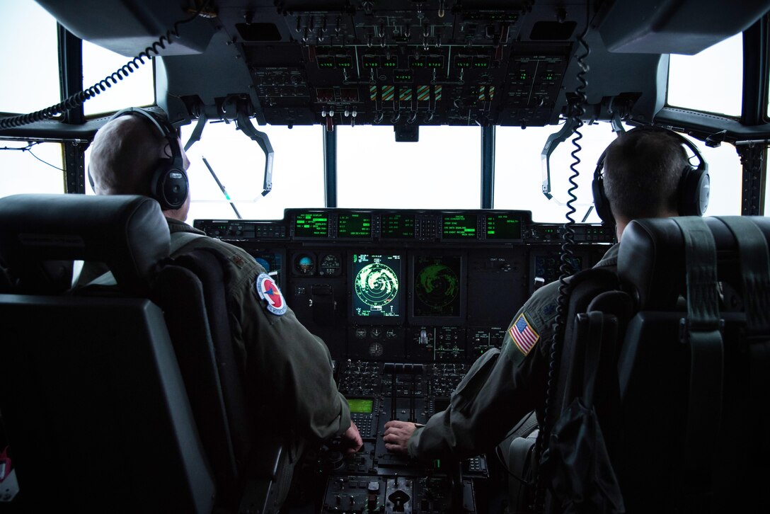 Two airmen pilot an aircraft.