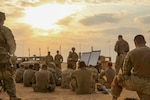 The Soldiers and leaders of Bravo Company, 3rd Battalion, 8th Cavalry Regiment, 3rd Armored Brigade Combat Team, 1st Cavalry Division gather around for the after-action review following their three-day company situational training exercise at Udairi Range Complex in Kuwait Aug. 12, 2017. The brigade organized this training event to sustain the readiness of the combined arms battalions. (U.S. Army photo by Staff Sgt. Leah R. Kilpatrick)