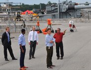 IMAGE: DAHLGREN, Va. (Aug. 21, 2017) - Jim Green, a Potomac River Test Range safety expert, briefs Science, Mathematics & Research for Transformation (SMART) Scholars about unique operations conducted on the Naval Surface Warfare Center Dahlgren Division (NSWCDD) main range that include high speed cameras and flight followers. "We are able to place them where needed to track projectiles from muzzle to impact," Green told the scholars. "In early 2000, the first two weapons systems  integrated with fire control at Dahlgren were the 5"/54 and 5"/62 caliber naval guns. This gave us the capability to track and fire at moving targets on the range which set the stage for other automatic weapon systems." The college students also toured the NSWCDD Electromagnetic Railgun Launch Facility. The Missile Defense Agency sponsored the college students who are among those pursuing a degree in, or closely related to, science, technology, engineering, and mathematics disciplines through the Department of Defense SMART Scholar program. Students selected for SMART Scholarships are offered internships and a stepping stone to future civilian job opportunities in the federal government.