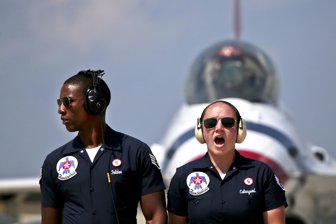 One airman looks off-camera as another yells.
