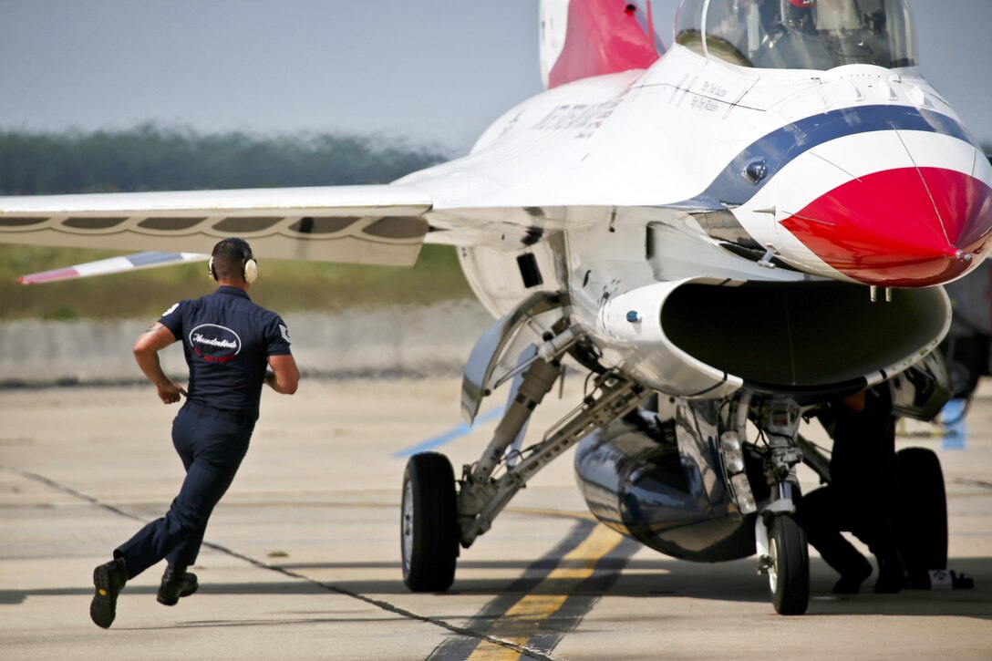 An airman runs to an aircraft