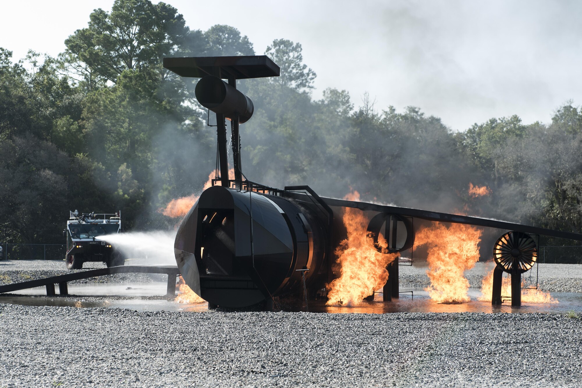 Firefighters from the 23d Civil Engineer Squadron douse flames during live fire training at Moody Air Force Base, Ga., Aug. 24, 2017. This training is an annual requirement for Moody firefighters and is just one of the ways they stay ready to protect people, property and the environment from fires and disasters. (U.S. Air Force photo by Staff Sgt. Olivia Dominique)