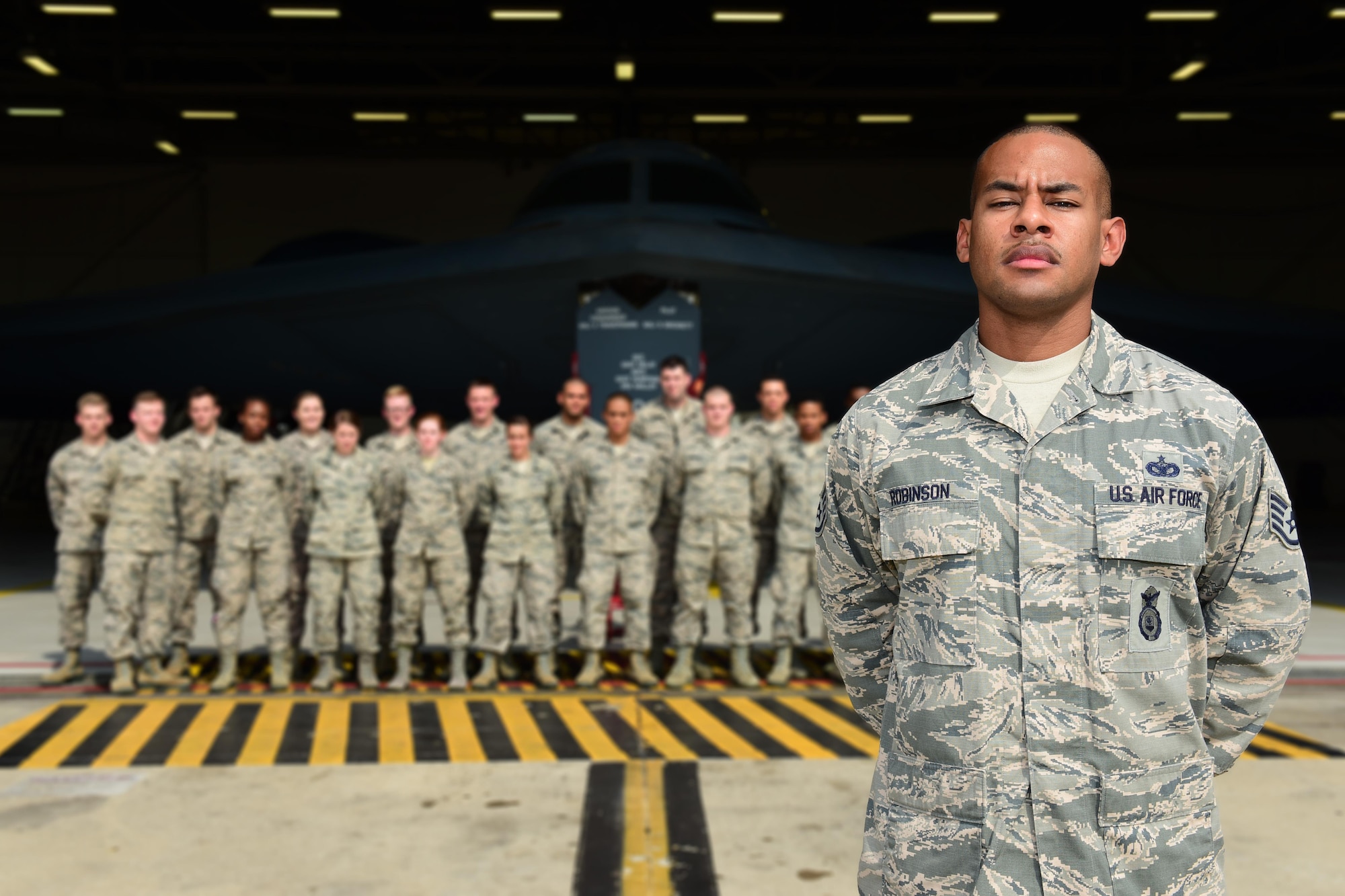 U.S. Air Force Staff Sgt. Bryan Robinson, the First Term Airmen Course (FTAC) NCO in charge, leads the revamped FTAC class at Whiteman Air Force Base, Mo. The new FTAC is a five-day class that consists of briefs from different base agencies, 13 hours of professionalism training and tours of a B-2 Spirit and the Oscar-1 Minuteman Missile Alert Facility. (U.S. Air Force photo/Staff Sgt. Danielle Quilla)