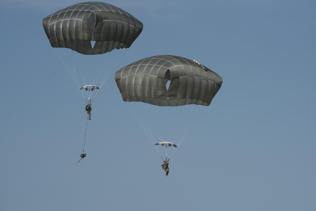 Soldiers with Headquarters and Headquarters Battery, 2nd Battalion, 319th Field Artillery Regiment, perform a combat equipment airborne jump with the new Joint Effects Targeting System.