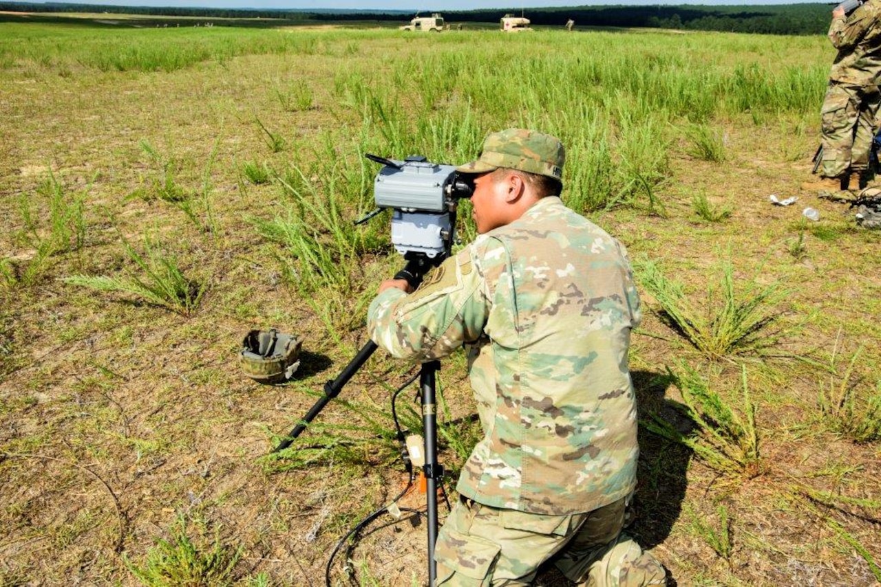 Army Pvt. 1st Class Preshelemiah Hitgano, of Headquarters and Headquarters Battery, 2nd Battalion, 319th Field Artillery Regiment, sets up the Joint Effects Targeting System.