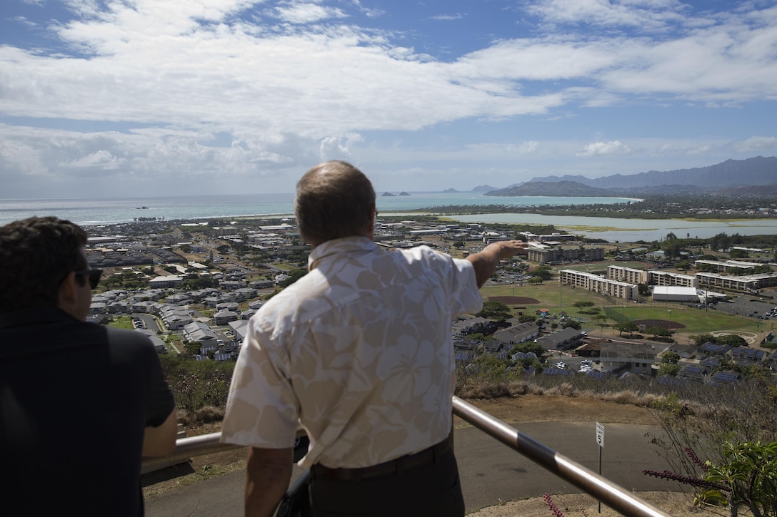 U.S. Sen. Brian Schatz, Hawaii, views Marine Corps Base Hawaii (MCBH) from the top of Kansas Tower alongside Mr. Bob Lottie, director, Installations Environmental and Logistics, aboard MCBH, Aug. 24, 2017. Schatz traveled to MCBH to discuss and learn more about concerns regarding capabilities, readiness, and future challenges to Marines in the region and discussed the projection of power, production of readiness, and promotion of resiliency with current and future military projects. (U.S. Marine Corps photo by Sgt. Alex Kouns/Released)
