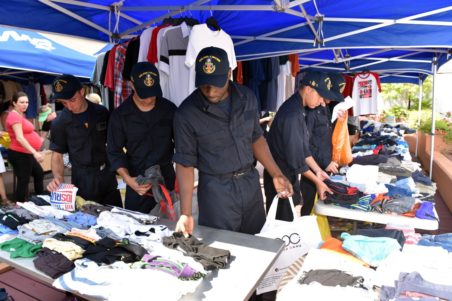 SINGAPORE (Aug. 23, 2017) Sailors from the USS John S. McCain (DDG 56) are assisted by volunteers in looking for personal items donated by community members of the Singapore Area Coordinator. The McCain sustained significant damage following a collision with the merchant vessel Alnic MC while underway east of the Strait of Malacca and Singapore on Aug. 21, 2017.