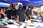 SINGAPORE (Aug. 23, 2017) Sailors from the USS John S. McCain (DDG 56) are assisted by volunteers in looking for personal items donated by community members of the Singapore Area Coordinator. The McCain sustained significant damage following a collision with the merchant vessel Alnic MC while underway east of the Strait of Malacca and Singapore on Aug. 21, 2017.