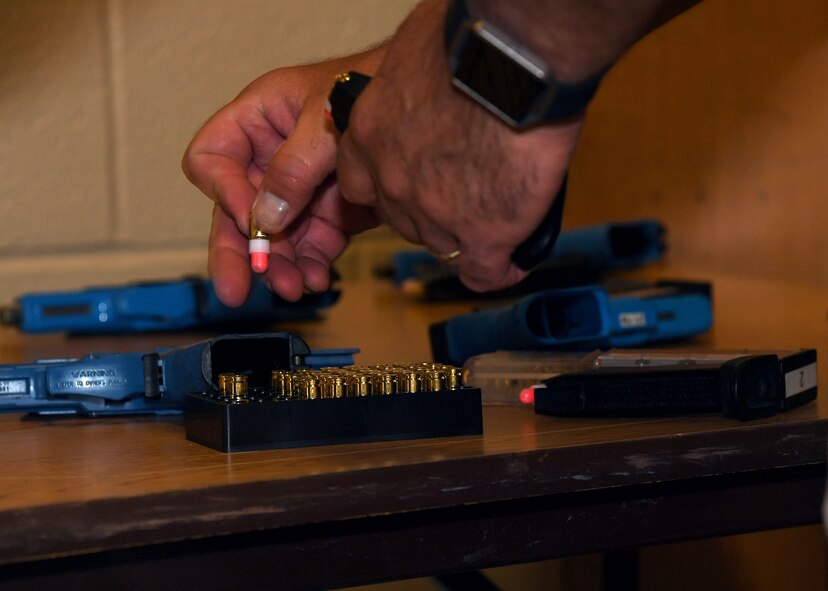 A U.S. Customs and Border Protection supervisory agent refills magazines with non-lethal, paint-filled ammunition for simulation weapons given to the active-shooter training participants at Carl Ben Eielson Elementary School Aug. 10, 2017 on Grand Forks Air Force Base, N.D. Participants had the option to use either a rifle or pistol, and were instructed to use the weapons as they would in a real scenario. (U.S. Air Force photo by Airman 1st Class Elora J. Martinez)