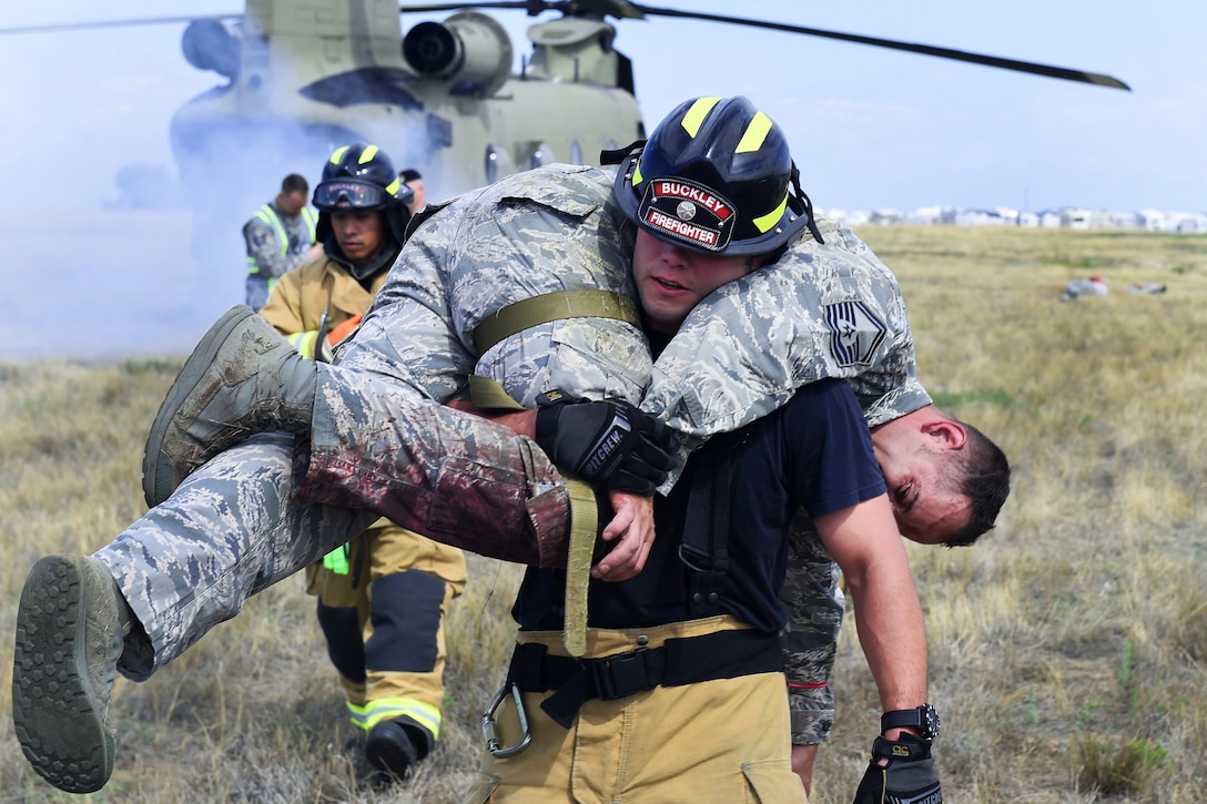 An airman carriers a mock casualty to a safety point.