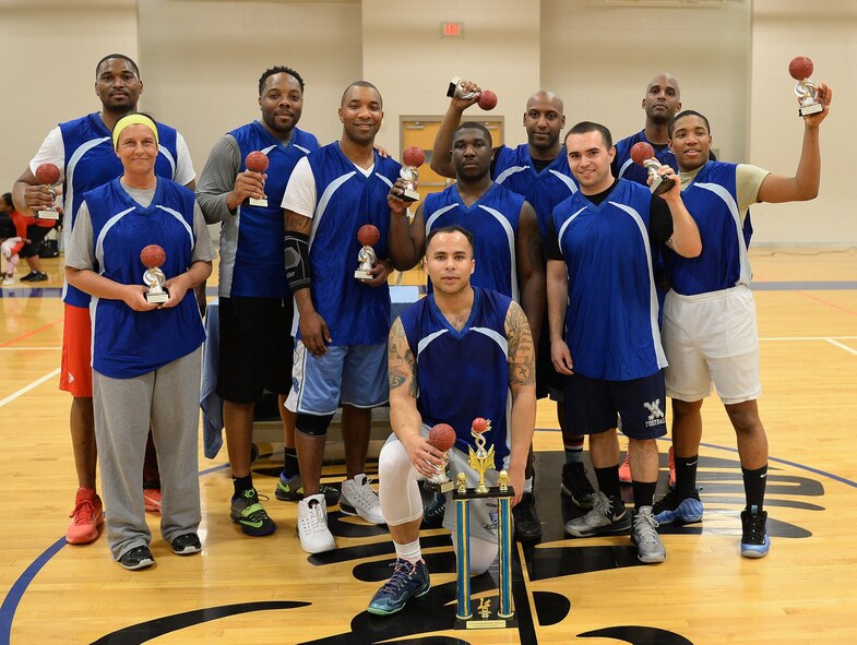 Juston White, back left, 22nd Logistics Readiness Squadron honorary commander, poses with the LRS team after winning the intramural basketball championship, Feb. 16, 2017, at McConnell Air Force Base, Kan. White played college basketball while attending Wichita State University. (Courtesy photo)