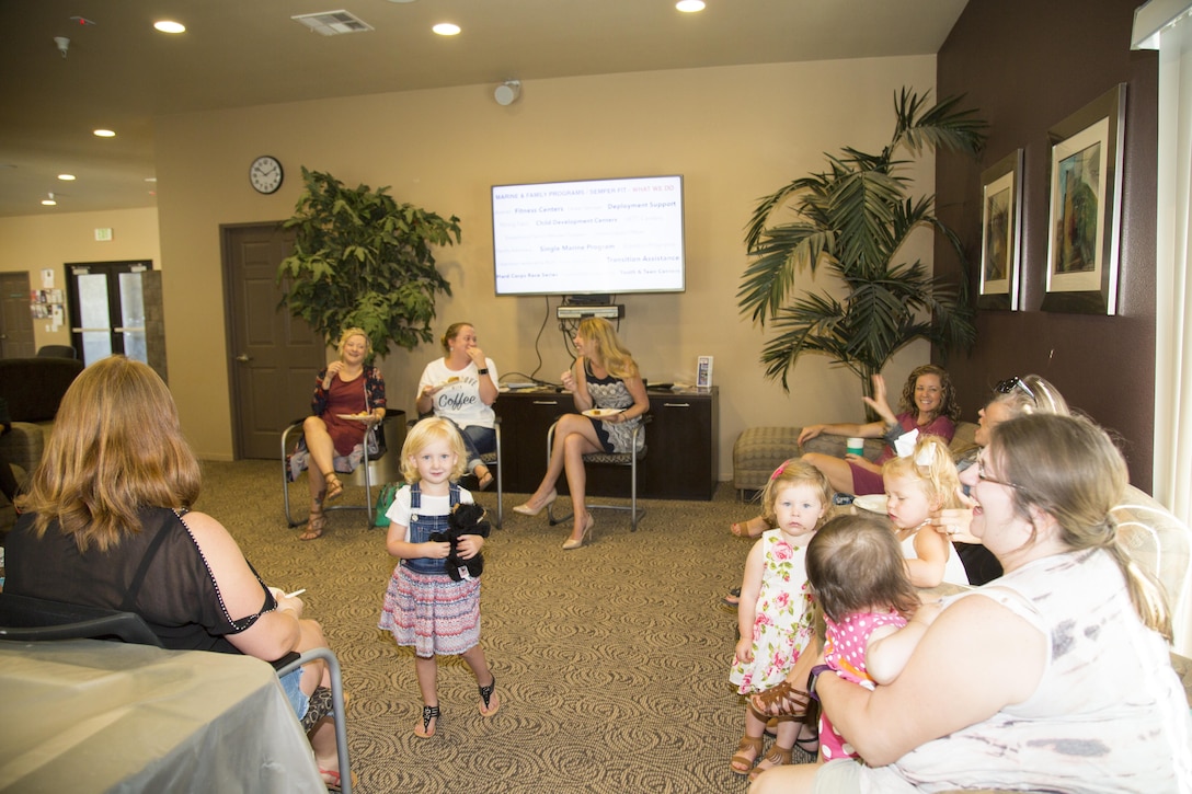 Ashley Ignatz, Marine Corps Family Team Building trainer, engages Marine Corps families in a Welcome Aboard: Spouse Edition event held at the Desert View Housing Community Center aboard Marine Corps Logistics Base Barstow, Calif. Aug. 17. The event, tailored specifically to military spouses and their children, provides an opportunity for families to meet their neighbors, learn about the resources available on base, enjoy a potluck, and ask questions in an informal setting.