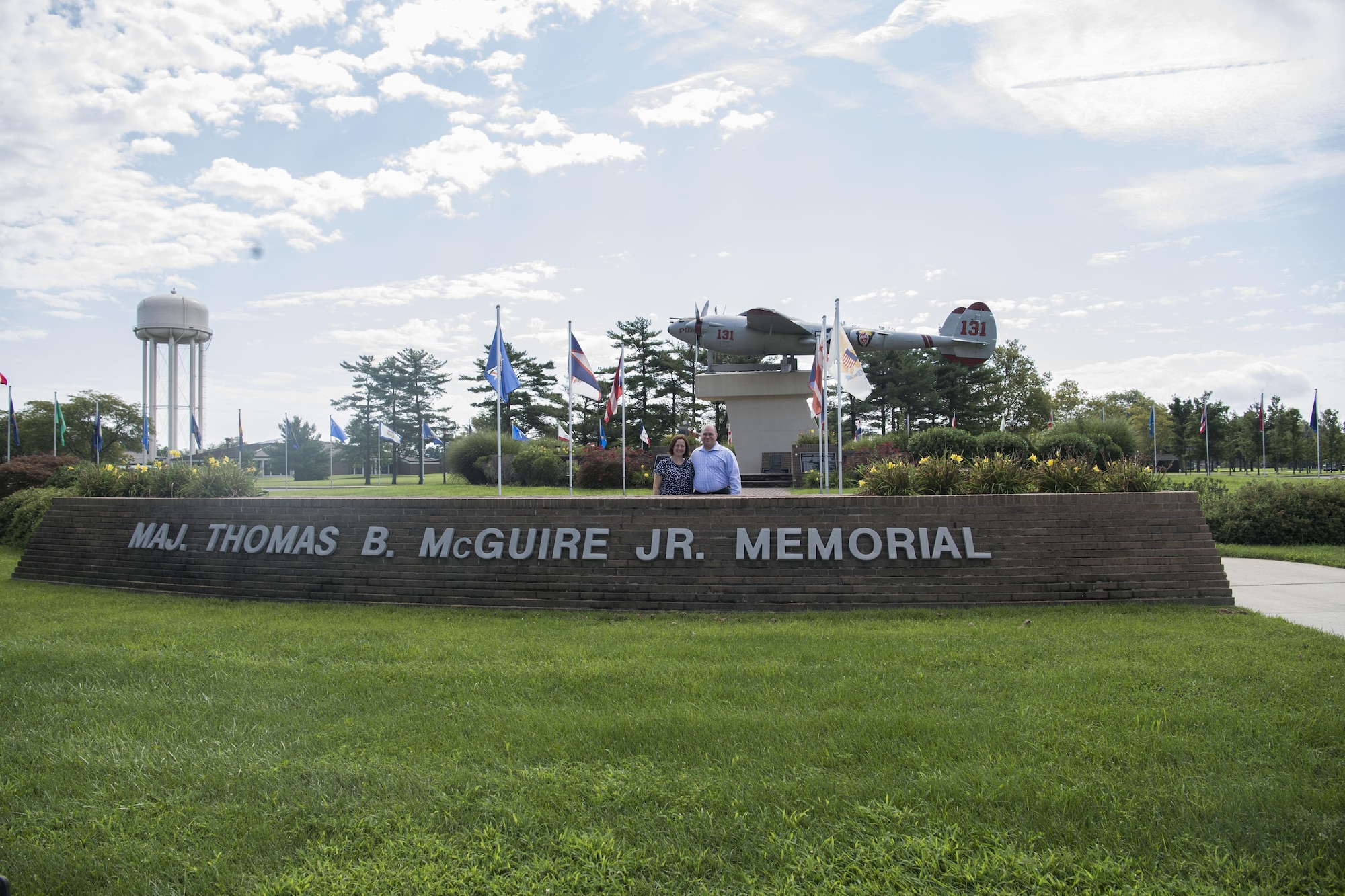 Tara Bufis and John Levitow Jr., niece and son of Medal of Honor recipient Sgt. John Levitow, pose under Pudgy, the P-38 Lightning static display on Joint Base McGuire-Dix-Lakehurst, N.J., Aug. 24, 2017. Members of the Levitow family toured the joint base to learn more about the life and legacy of the late veteran. (U.S. Air Force photo by Senior Airman Lauren Russell)