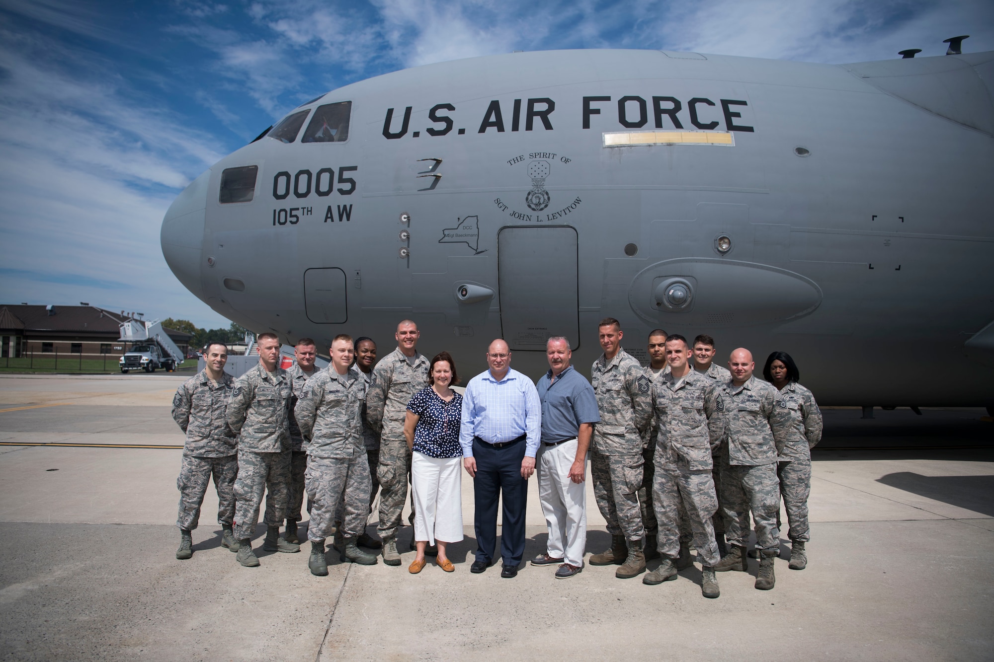 John Levitow Jr., center, along with his cousin, Tara Bufis and her husband, James, pose with Levitow Award winners in front of the "Spirit of Sgt. John Levitow," New York Air National Guard Globemaster III during a tour of Joint Base McGuire-Dix-Lakehurst, N.J., Aug 24, 2017. Levitow Jr. spoke during the J MDL Airman Leadership School graduation of Troop 17F on his father's messages for the troops. (U.S. Air Force photo by Senior Airman Lauren Russell)