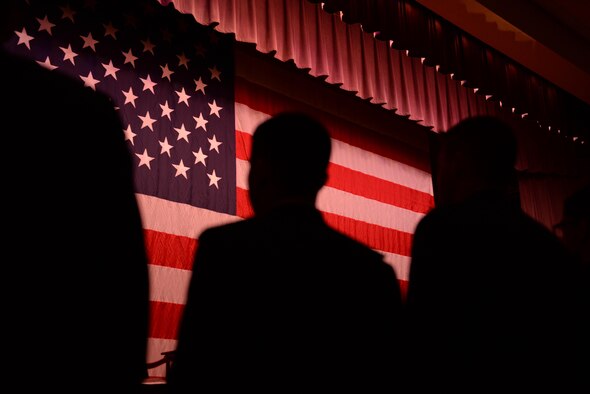 Graduates of Specialized Undergraduate Pilot Training Class 17-13 look at the flag Aug. 18, 2017, on Columbus Air Force Base, Mississippi, before singing the Air Force Song. From start to finish the SUPT program takes about 13 months and students will have flown roughly 200 hours in training aircraft at Columbus AFB upon graduation. (U.S. Air Force photo by Airman 1st Class Keith Holcomb)